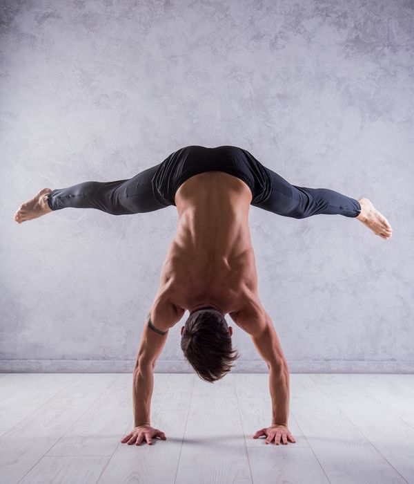 Athletic man performing stability and strength exercises indoors